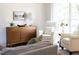 Comfortable sitting area features plush white chairs, a wood accent table, and natural light from the large window at 110 Stoney Dr, Durham, NC 27703