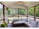 Screened in patio with ceiling fan, outdoor sectional and a view of the backyard at 110 Stoney Dr, Durham, NC 27703