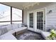 Inviting screened-in porch with comfortable seating and an outdoor rug at 110 Stoney Dr, Durham, NC 27703