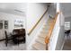 Carpeted staircase featuring a wooden handrail and banister at 110 Stoney Dr, Durham, NC 27703
