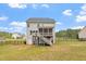 Large backyard featuring a well-maintained lawn, black fence, and a home with a screened porch at 113 Old Ballentine Way, Holly Springs, NC 27540