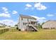 Spacious backyard with a well-maintained lawn, black fence, and a view of the home's exterior at 113 Old Ballentine Way, Holly Springs, NC 27540