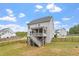 A sprawling backyard featuring well-maintained grass, black fence, and a deck at 113 Old Ballentine Way, Holly Springs, NC 27540