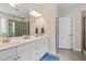 Contemporary bathroom with double vanity, white cabinets, and a walk-in shower at 113 Old Ballentine Way, Holly Springs, NC 27540