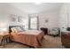 Cozy bedroom features a full-sized bed, soft lighting, and a decorative chair at 113 Old Ballentine Way, Holly Springs, NC 27540