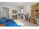 Charming bonus room features a blue sofa, bright sunlight, and a decorative National Parks art piece at 113 Old Ballentine Way, Holly Springs, NC 27540