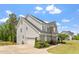 A beautifully landscaped home features a two-car garage and meticulous lawn care at 113 Old Ballentine Way, Holly Springs, NC 27540