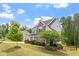 Well maintained lawn with mature trees and shrubbery that enhances the curb appeal of this home at 113 Old Ballentine Way, Holly Springs, NC 27540