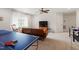 Large game room features a ping pong table, seating, and abundant space for activities at 113 Old Ballentine Way, Holly Springs, NC 27540