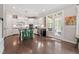 Bright kitchen with white cabinetry, stainless steel appliances and island with green stools at 113 Old Ballentine Way, Holly Springs, NC 27540