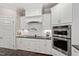 Contemporary kitchen with white cabinets, tile backsplash, and stainless steel oven appliance at 113 Old Ballentine Way, Holly Springs, NC 27540