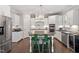 Modern kitchen featuring white cabinets, sleek countertops, stainless appliances, and a center island at 113 Old Ballentine Way, Holly Springs, NC 27540
