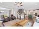 Open-concept living room featuring hardwood floors, a fireplace, and stylish furniture at 113 Old Ballentine Way, Holly Springs, NC 27540