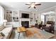 Inviting living room with fireplace, built-in shelves, ceiling fan and stylish decor at 113 Old Ballentine Way, Holly Springs, NC 27540