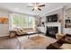 Inviting living room featuring a fireplace, built-in shelving, and large windows at 113 Old Ballentine Way, Holly Springs, NC 27540