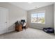 Well-lit office includes a traditional desk, a large window, and plush carpet at 113 Old Ballentine Way, Holly Springs, NC 27540
