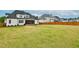 Spacious backyard featuring lush lawn, privacy fence and screened in porch area, perfect for outdoor activities at 1180 Duke Farm Dr, Wake Forest, NC 27587