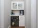 Stylish bar area with a beverage fridge, ice maker, and glass storage cabinets at 1180 Duke Farm Dr, Wake Forest, NC 27587