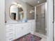 Stylish bathroom with glass enclosed shower, white cabinets, and designer rug at 1180 Duke Farm Dr, Wake Forest, NC 27587