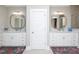 Bright bathroom featuring double vanity with framed mirrors and bright patterned rug at 1180 Duke Farm Dr, Wake Forest, NC 27587