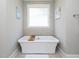Luxurious white freestanding tub in a spa-like bathroom retreat at 1180 Duke Farm Dr, Wake Forest, NC 27587