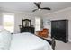 Bedroom with an accent chair, neutral walls, and dark wooden furniture at 1180 Duke Farm Dr, Wake Forest, NC 27587