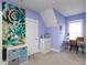 Well-lit bedroom with a succulent art piece, white trim, and a quaint study area at 1180 Duke Farm Dr, Wake Forest, NC 27587