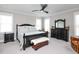 Comfortable bedroom featuring dark furniture, neutral walls, and natural light from two windows at 1180 Duke Farm Dr, Wake Forest, NC 27587