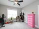 Inviting bedroom with a ceiling fan, large window, and exercise equipment at 1180 Duke Farm Dr, Wake Forest, NC 27587