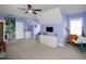 Spacious bedroom featuring stylish purple walls, modern furnishings, and plush carpeting at 1180 Duke Farm Dr, Wake Forest, NC 27587