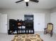 Finished bonus room featuring built-in shelving and storage cabinets with a ceiling fan and neutral carpet at 1180 Duke Farm Dr, Wake Forest, NC 27587
