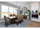 Cozy dining room with a wooden table, upholstered chairs, large windows, and built in oven at 1180 Duke Farm Dr, Wake Forest, NC 27587