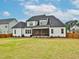 Rear exterior view of a spacious house with a screened porch and ample yard space at 1180 Duke Farm Dr, Wake Forest, NC 27587