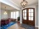 Elegant foyer featuring double doors, hardwood floors, and a dining area with stylish accents at 1180 Duke Farm Dr, Wake Forest, NC 27587