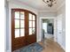 Inviting foyer features hardwood floors, a view into another room, and a charming entryway rug at 1180 Duke Farm Dr, Wake Forest, NC 27587