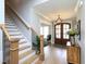 Welcoming foyer with wood floors, an elegant chandelier, and a staircase on the left side of the image at 1180 Duke Farm Dr, Wake Forest, NC 27587