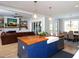 Open kitchen with wood island, stainless sink, and view of the living room with a fireplace and a brown leather couch at 1180 Duke Farm Dr, Wake Forest, NC 27587