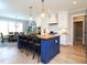 Modern kitchen island with pendant lights, seating, and views of the adjacent dining and kitchen areas at 1180 Duke Farm Dr, Wake Forest, NC 27587