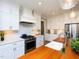 Well-lit kitchen with white herringbone backsplash, stainless steel appliances, and a wooden island with a prep sink at 1180 Duke Farm Dr, Wake Forest, NC 27587