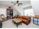 Cozy living room featuring a leather sofa, bookcase, and inviting decor at 1180 Duke Farm Dr, Wake Forest, NC 27587