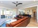 Bright living room featuring a leather couch and a screened patio in the background, with an open view of the kitchen at 1180 Duke Farm Dr, Wake Forest, NC 27587