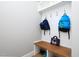 Clean mudroom featuring a wood bench, hooks, and built-in shelving for storage at 1180 Duke Farm Dr, Wake Forest, NC 27587