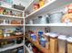 Well-organized pantry with multiple shelves filled with food items and storage containers at 1180 Duke Farm Dr, Wake Forest, NC 27587