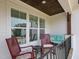 Cozy porch features rocking chairs, a loveseat, and views of the surrounding landscape at 1180 Duke Farm Dr, Wake Forest, NC 27587