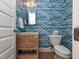 Stylish powder room featuring patterned wallpaper, carved wood vanity, and modern fixtures at 1180 Duke Farm Dr, Wake Forest, NC 27587