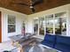 Relaxing screened-in porch with a dining table and lounge seating near a fireplace at 1180 Duke Farm Dr, Wake Forest, NC 27587