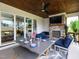Cozy screened-in porch with stone fireplace, outdoor seating, and dining table at 1180 Duke Farm Dr, Wake Forest, NC 27587
