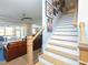 Elegant staircase featuring wood treads, white risers, and an open concept design leading to the living area at 1180 Duke Farm Dr, Wake Forest, NC 27587