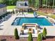Aerial view of the large backyard pool, fire pit, water slide, and pool house at 120 Lu Tom Ln, Wendell, NC 27591