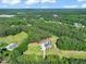 Wide aerial view of a home with a pool on a large lot surrounded by dense woodlands at 120 Lu Tom Ln, Wendell, NC 27591